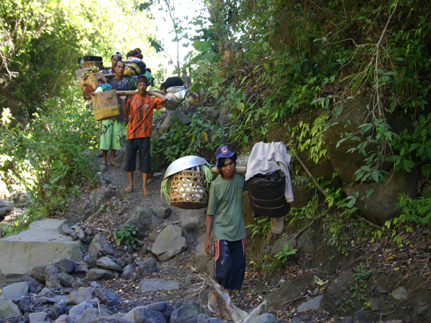 The porters of Mount Rinjani on flip flop carry heavy load